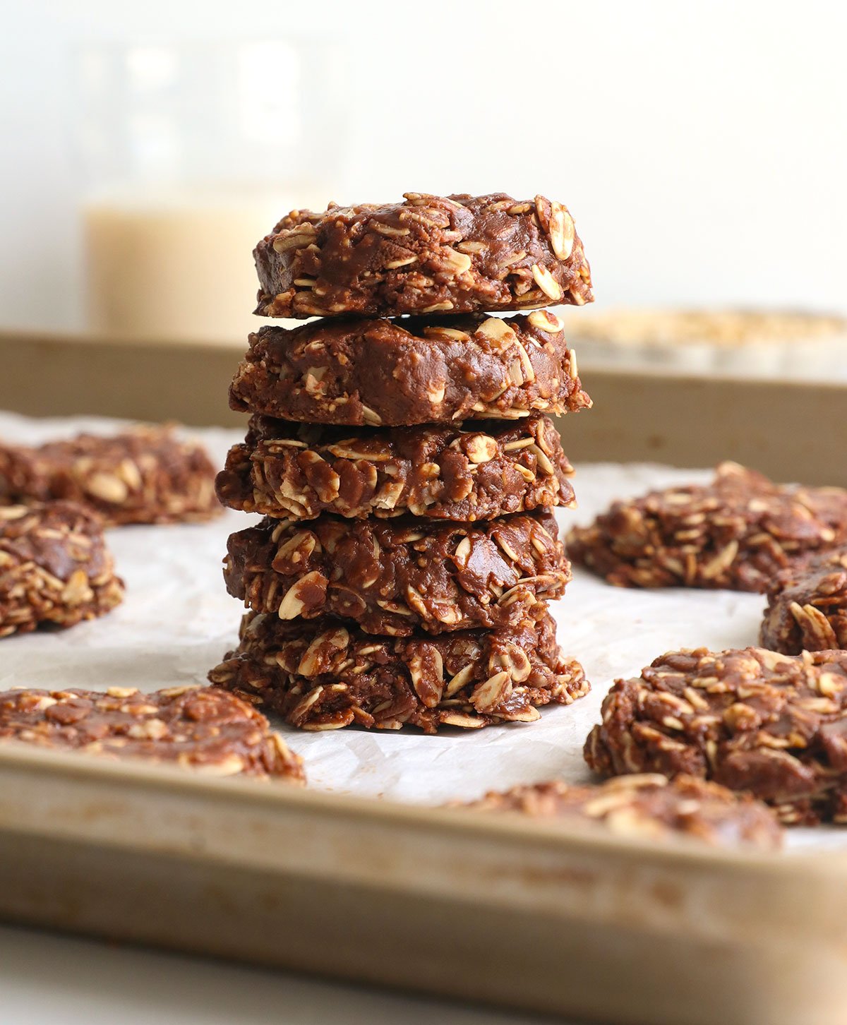 healthy no bake cookies stacked on a pan.