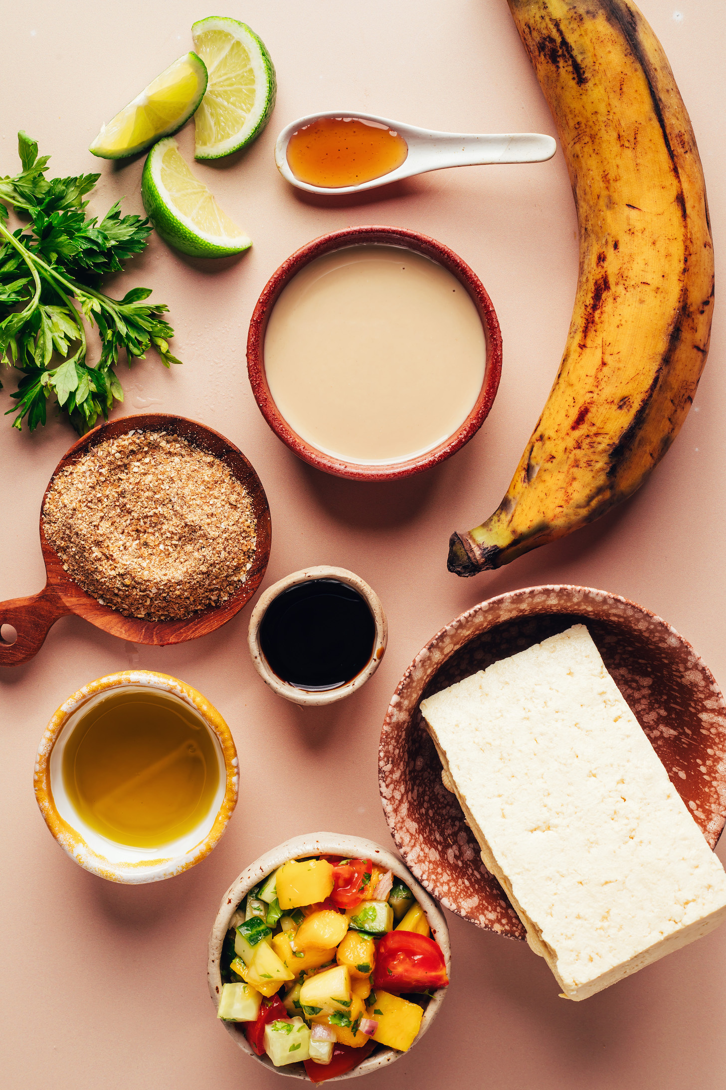 Tofu, plantain, tahini, maple syrup, lime wedges, parsley, Jerk seasoning, tamari, olive oil, and mango cucumber salad