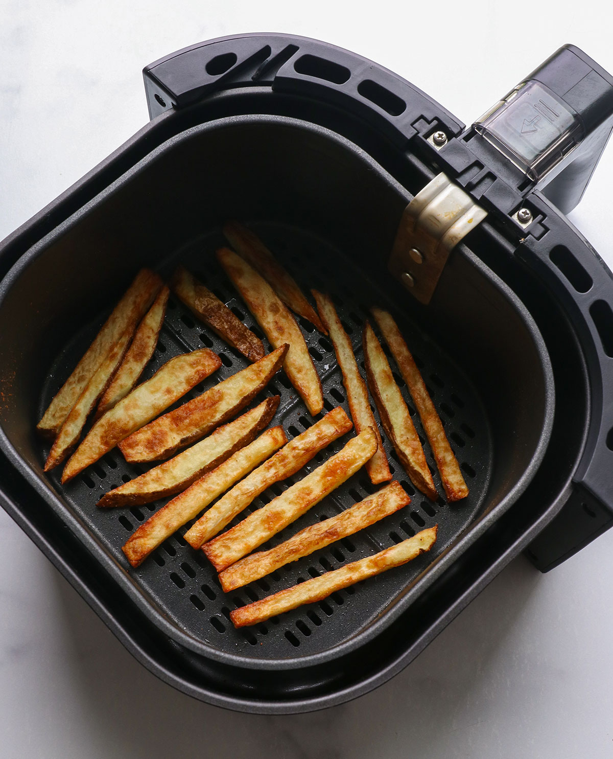cooked air fryer potatoes in the basket.