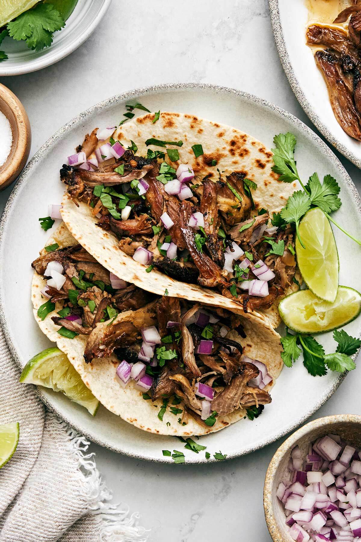 Carnitas tacos on a plate.