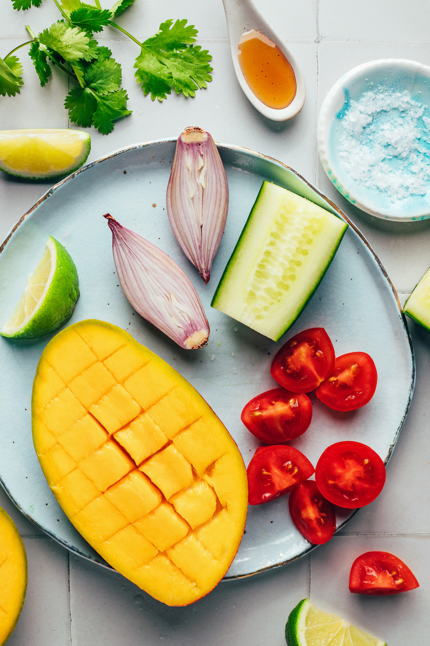 Mango, cucumber, cherry tomatoes, shallot, limes, cilantro, maple syrup, and salt