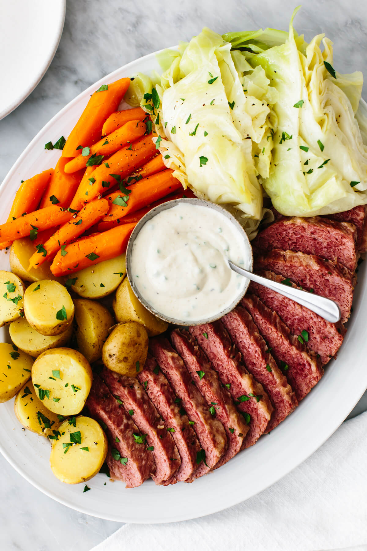 Corned Beef and cabbage and horseradish sauce on a plate
