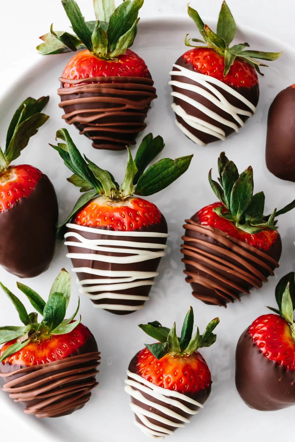 Chocolate covered strawberry drizzled in white and milk chocolate.