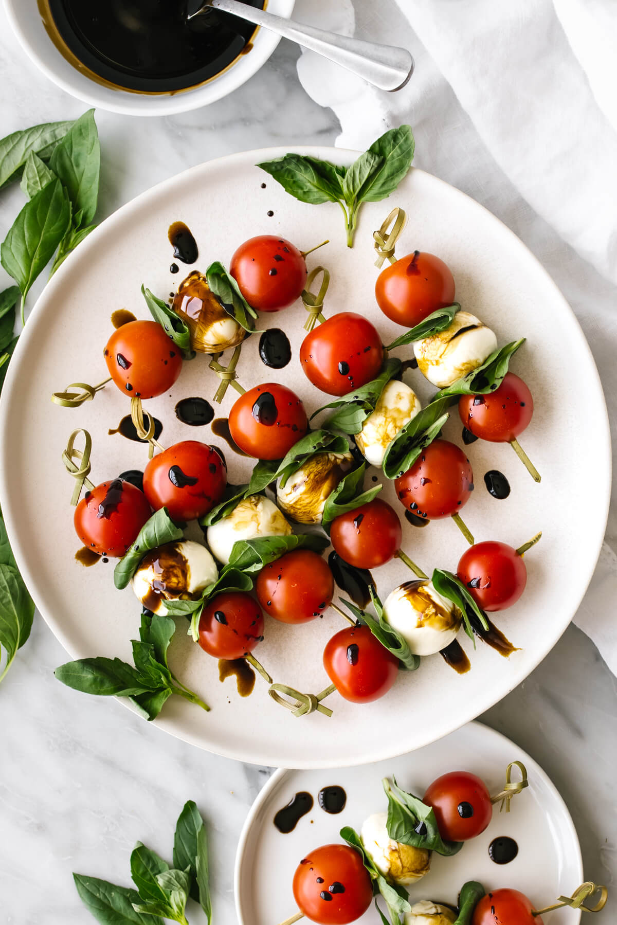Caprese skewers on a white plate