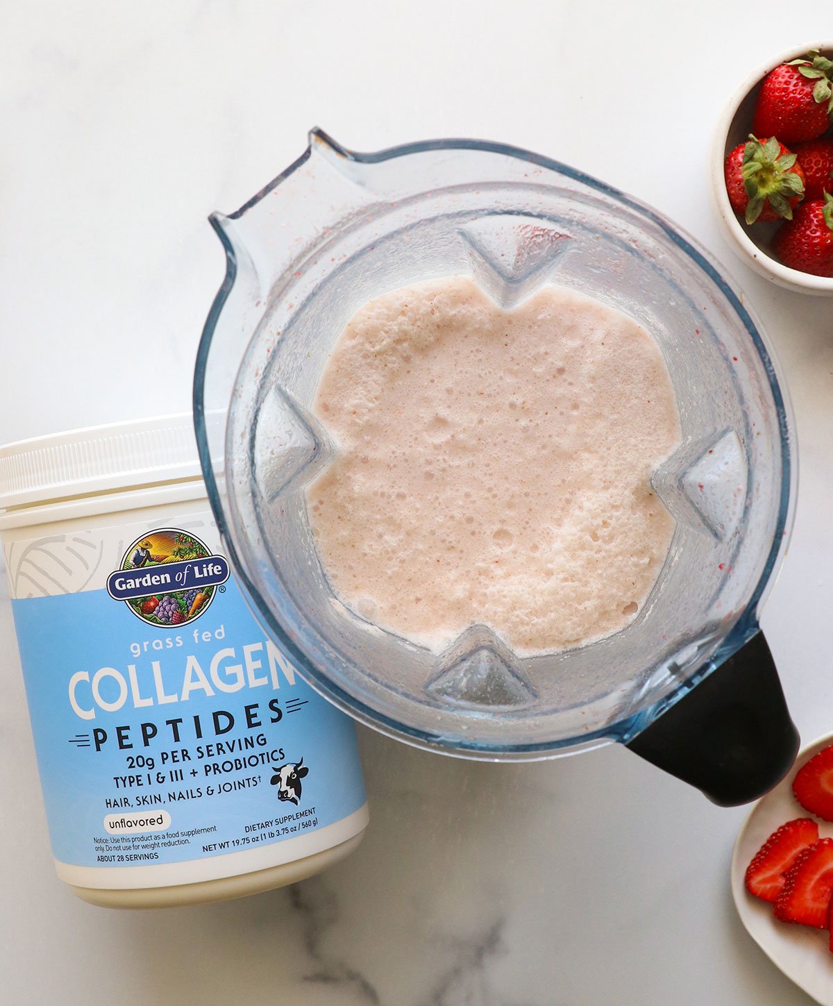collagen peptides added to a blender pitcher with pink drink.