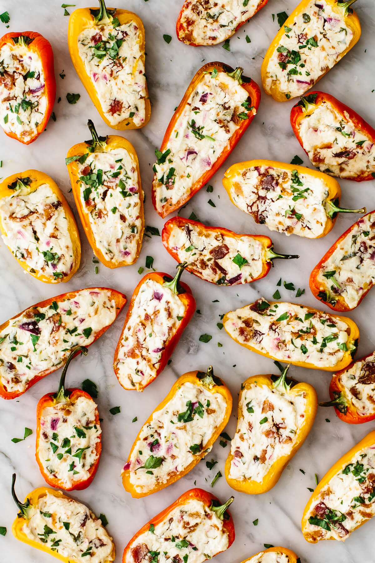 A table filled with bacon goat cheese stuffed peppers.