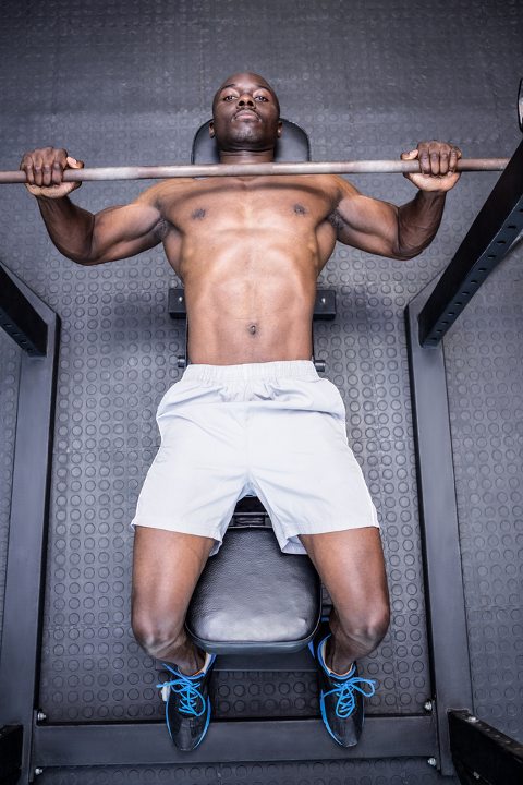 Man benching to build strength