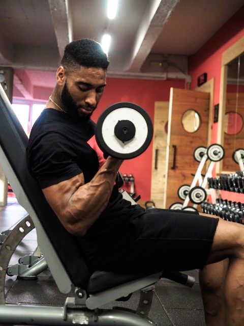 Man performing dumbbell bicep curls