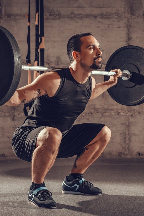 Man performing barbell squats