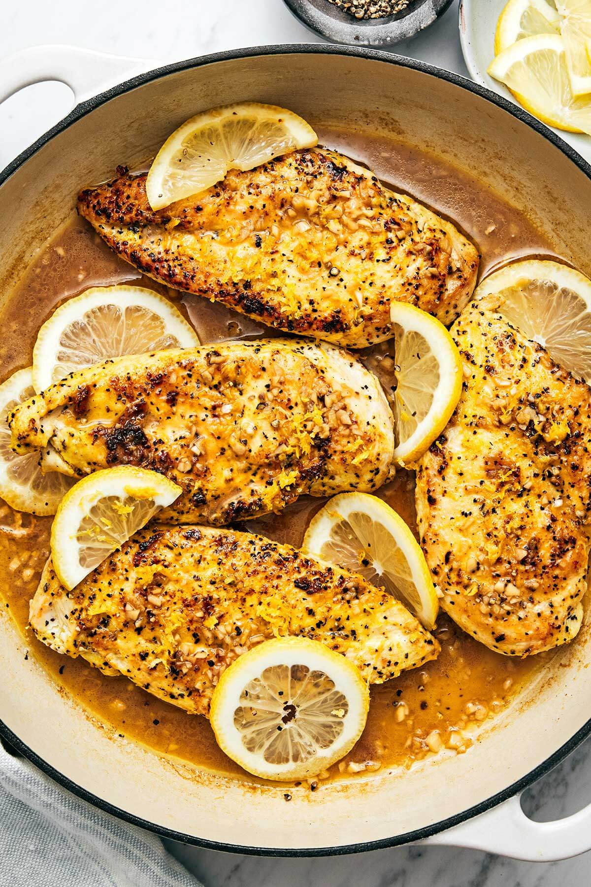 Lemon pepper chicken in a pan.