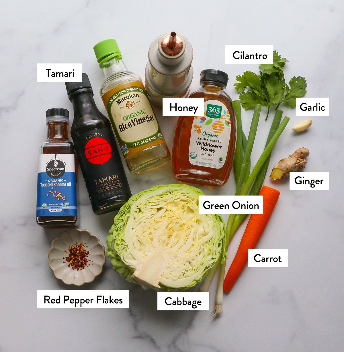 cabbage, honey, carrot, green onion, red pepper flakes, and cilantro labeled on a white board.