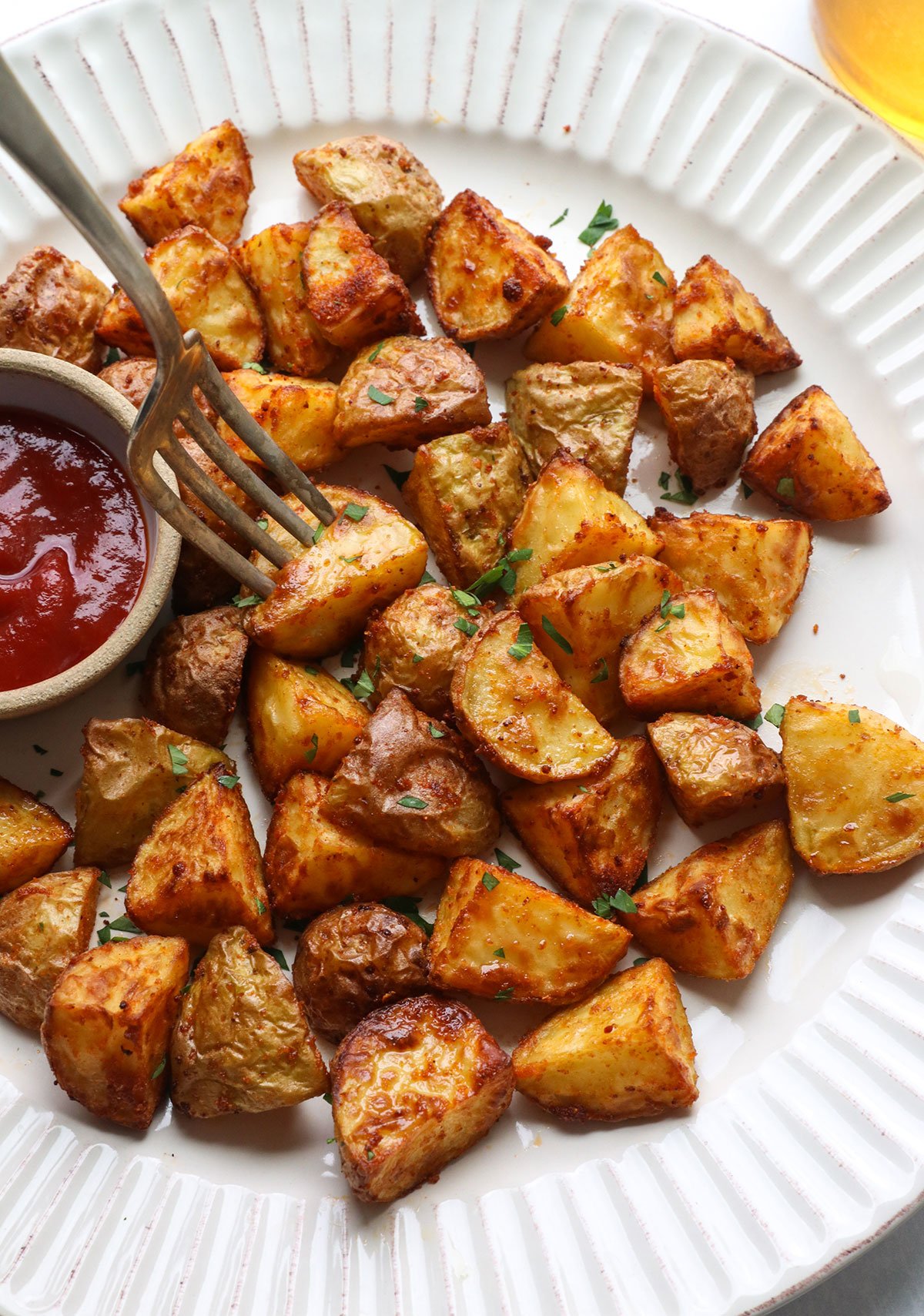 air fried potatoes on a white plate.