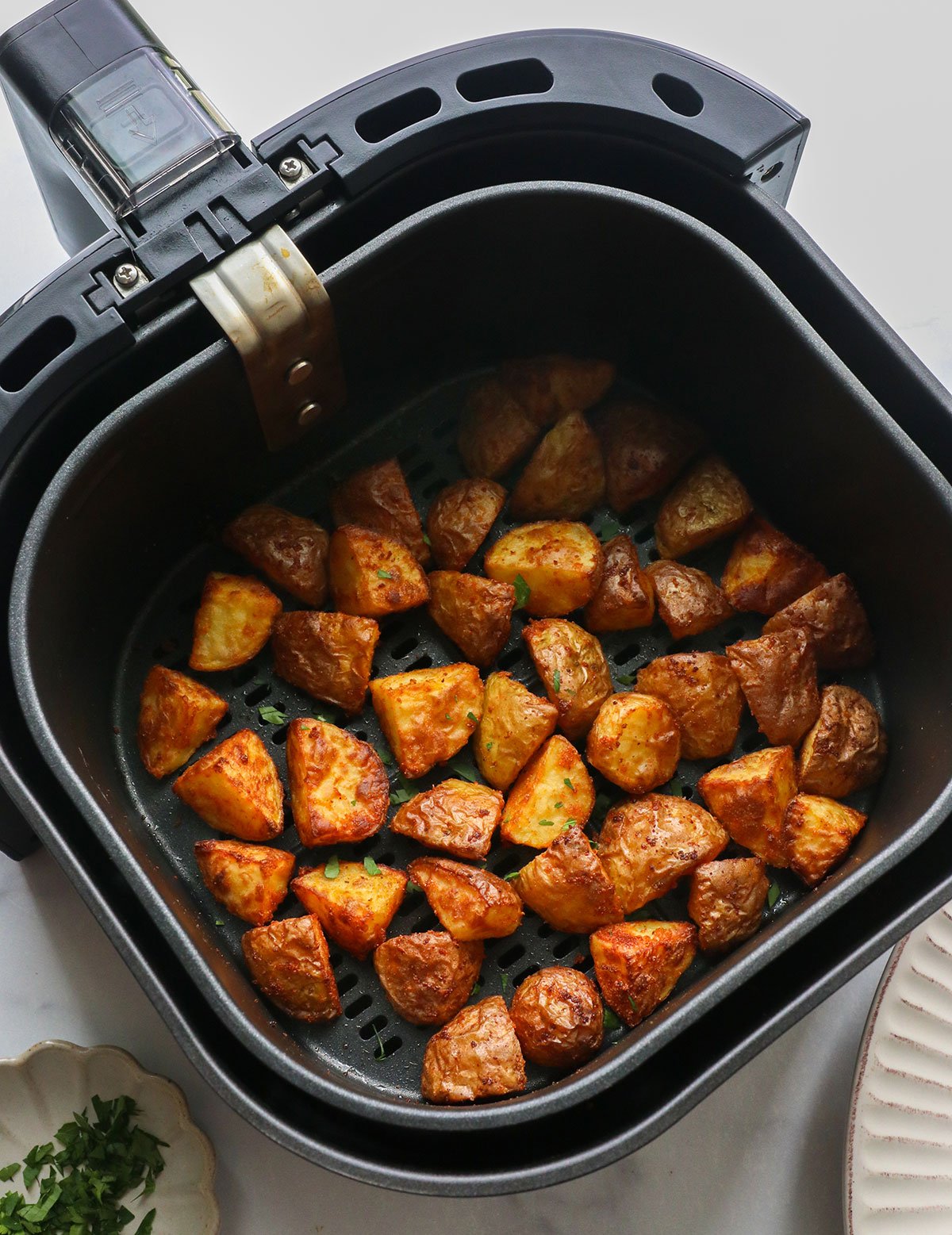 finished air fried potatoes in the air fryer basket