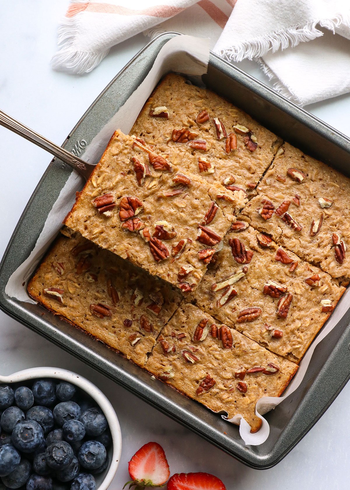 protein baked oatmeal topped with pecans and cut into 6 slices.