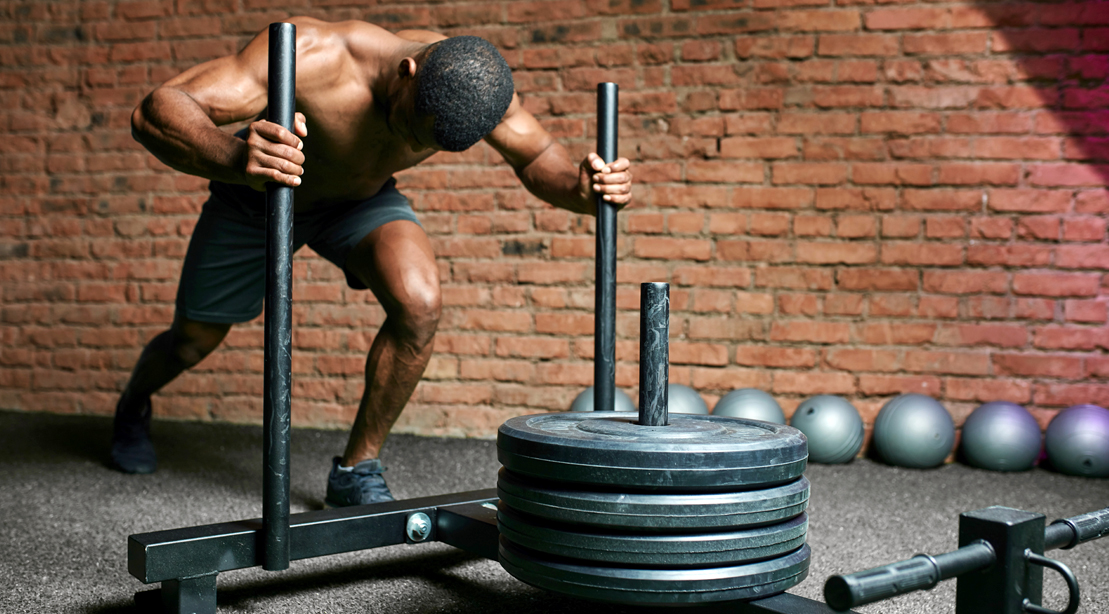 Man-Pushing-Weighted-Sled-Prowler