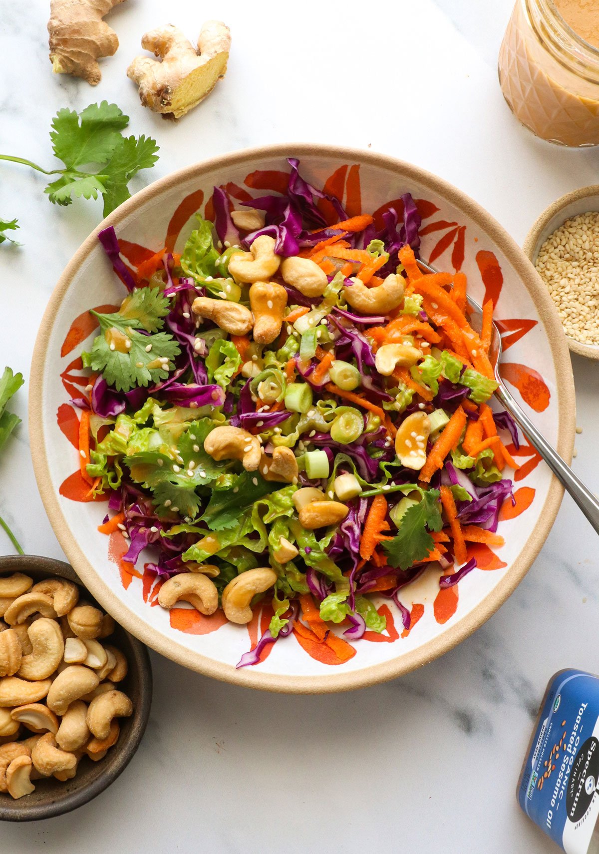 salad topped with cashews and ginger dressing.