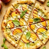 peach pizza sliced on a cutting board