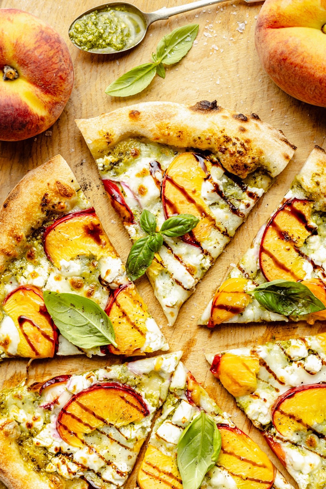 peach pizza sliced on a wooden board