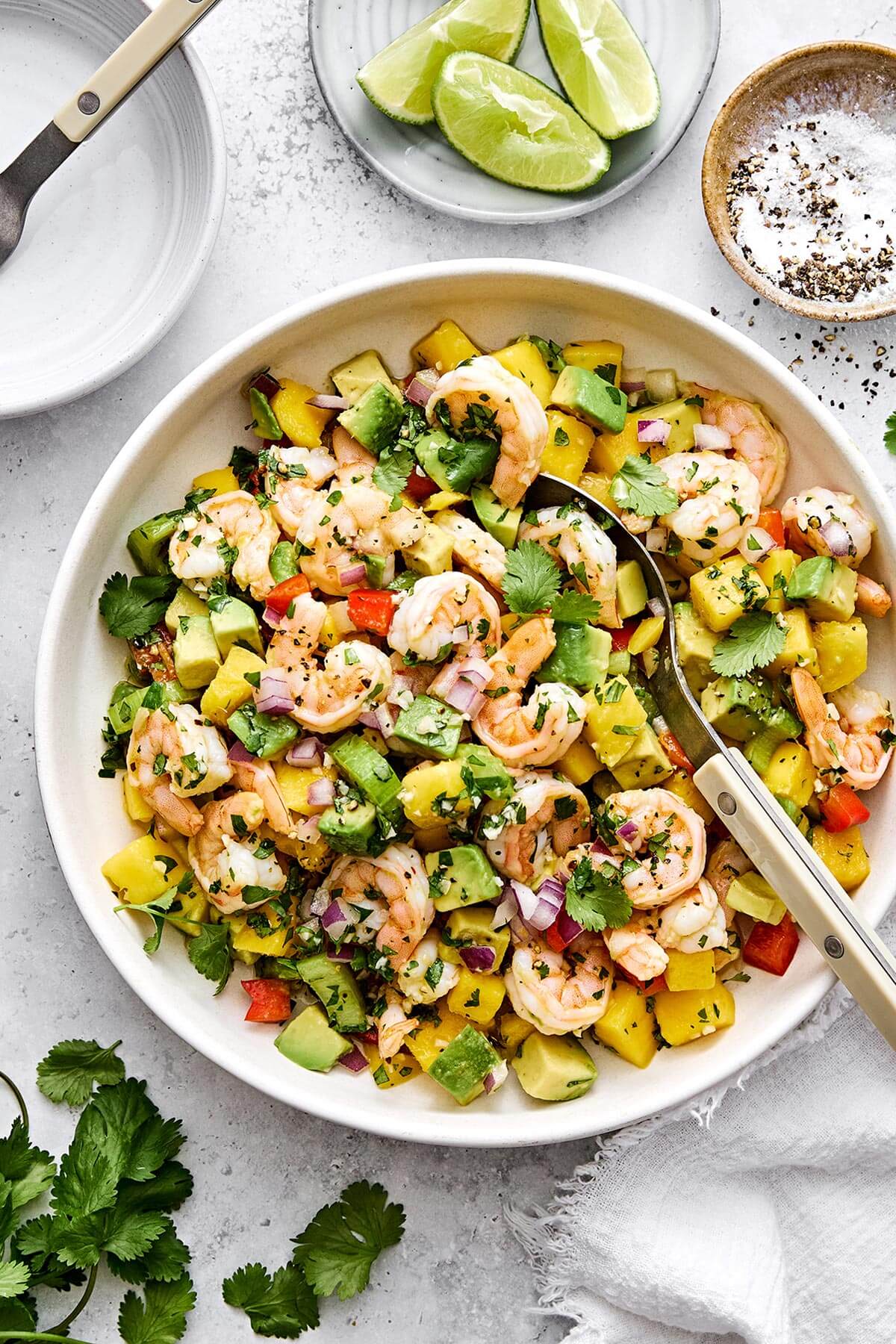 A bowl of mango avocado shrimp salad.