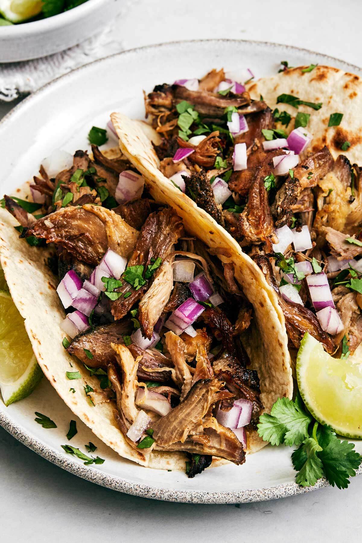 A plate of carnitas tacos.