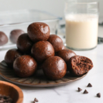 Chocolate protein balls with dates on a plate.