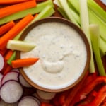greek yogurt ranch dressing in a bowl served with sliced veggies.