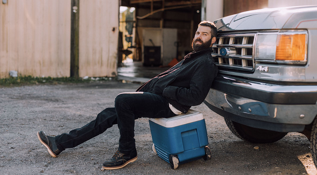 Jordan Davis leaning against a ford pickup