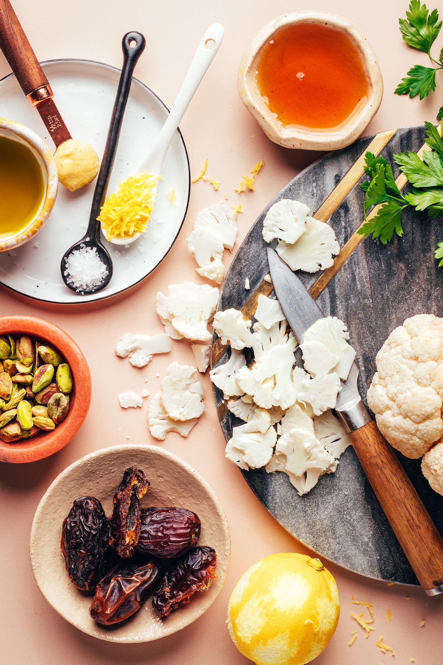 Lemon, dates, pistachios, lemon zest, salt, olive oil, Dijon mustard, maple syrup, parsley, and cauliflower