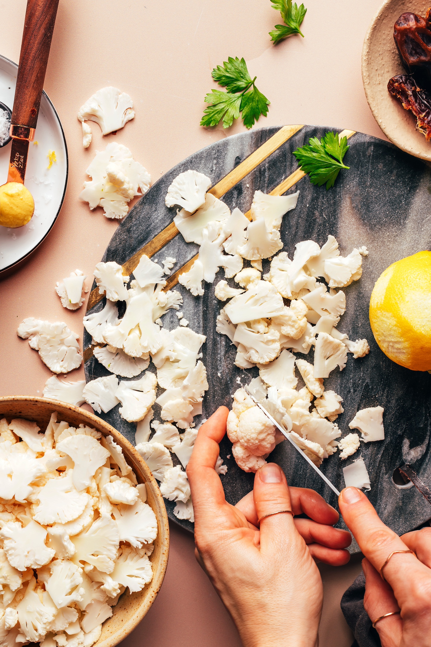 Thinly slicing cauliflower on a cutting board