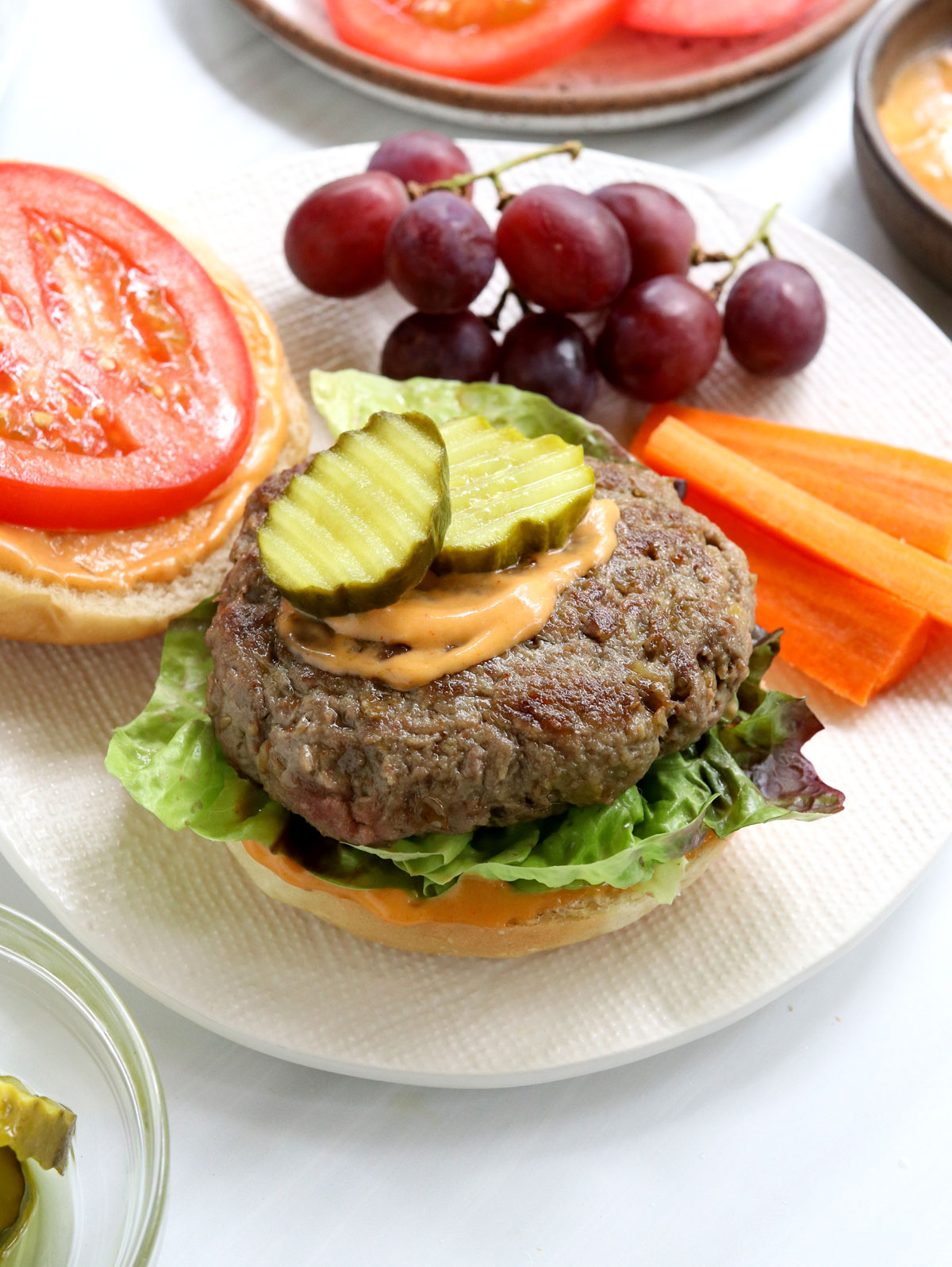 beef and lentil burger topped with pickles and special sauce.