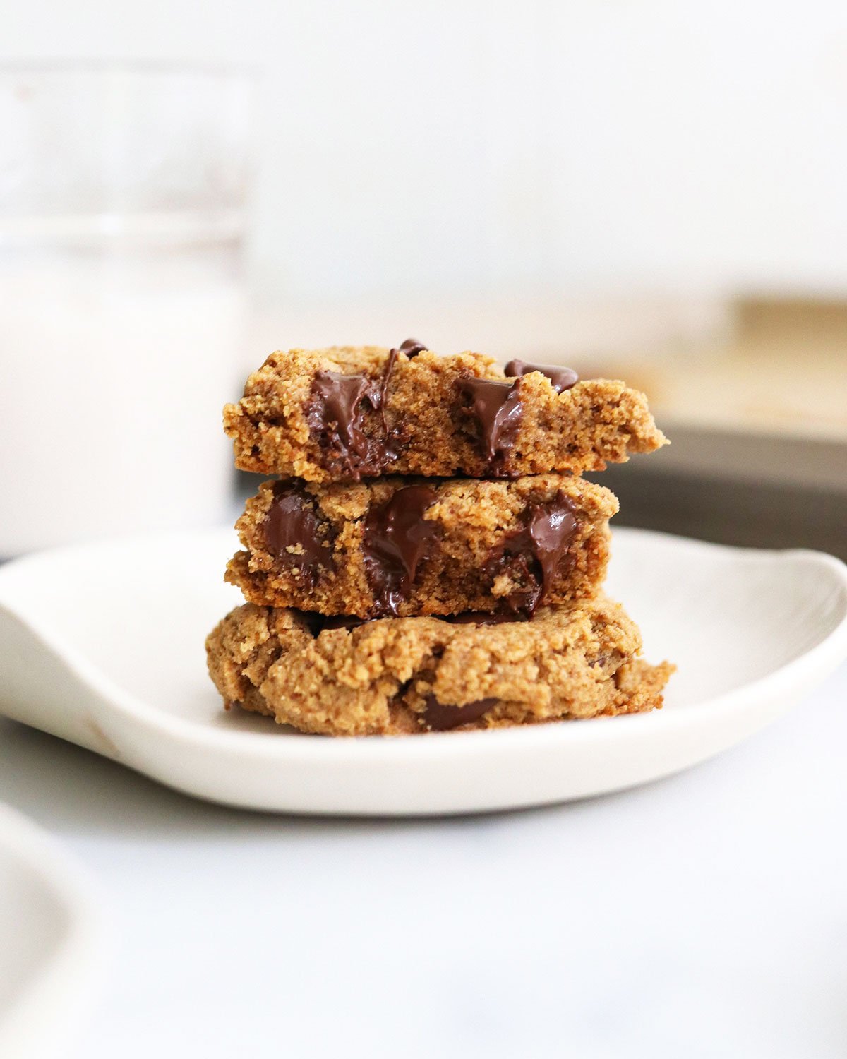 protein cookies split in half and stacked on plate.