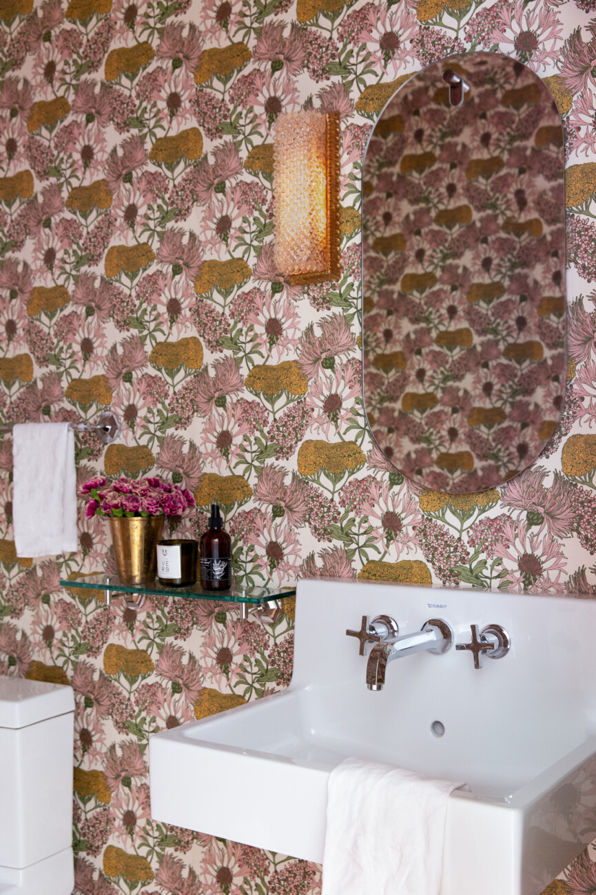 A powder room with floral wallpaper