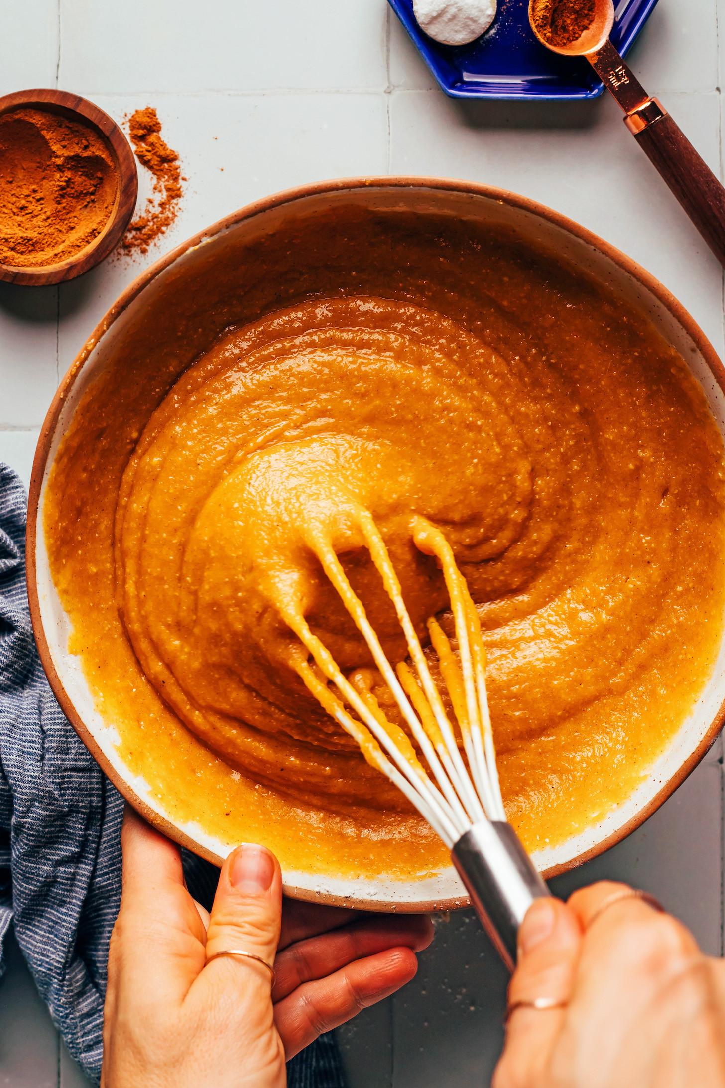 Using a whisk to mix pumpkin bread batter