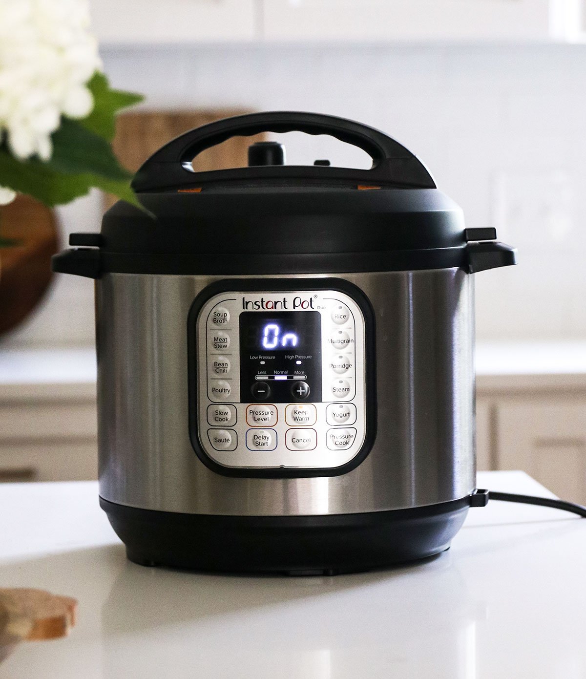 instant pot on the counter with the screen reading "on"