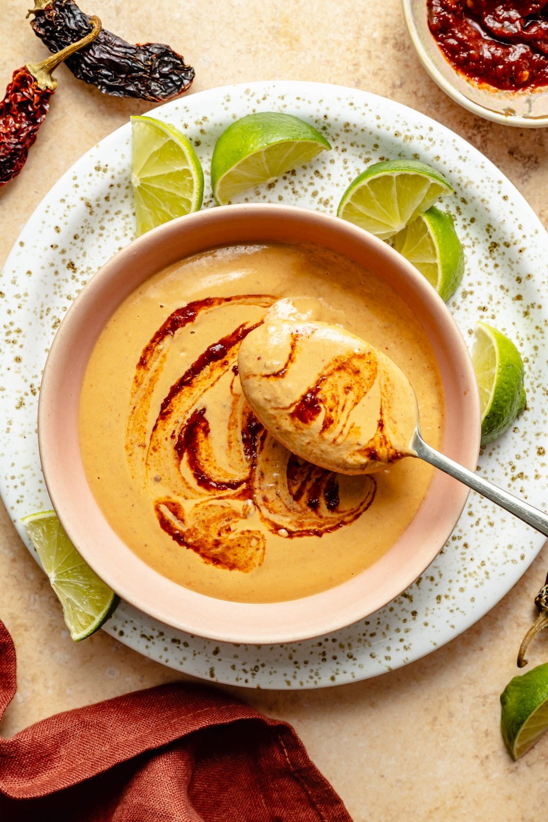 spooning chipotle tahini sauce out of a bowl