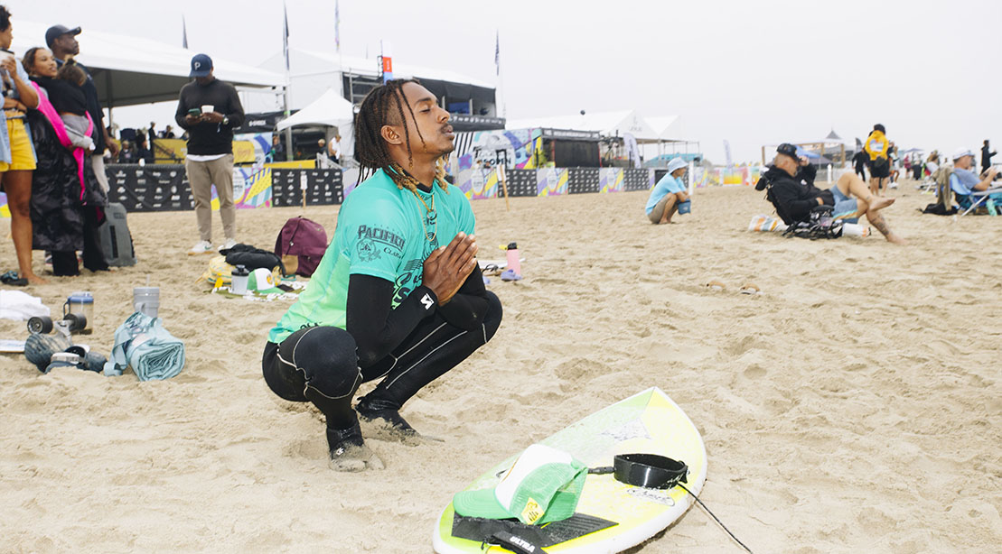 Surfer Julian Williams meditating and stretching before competing in a surfing competition