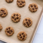 chocolate chip protein cookies baked on a parchment lined pan.