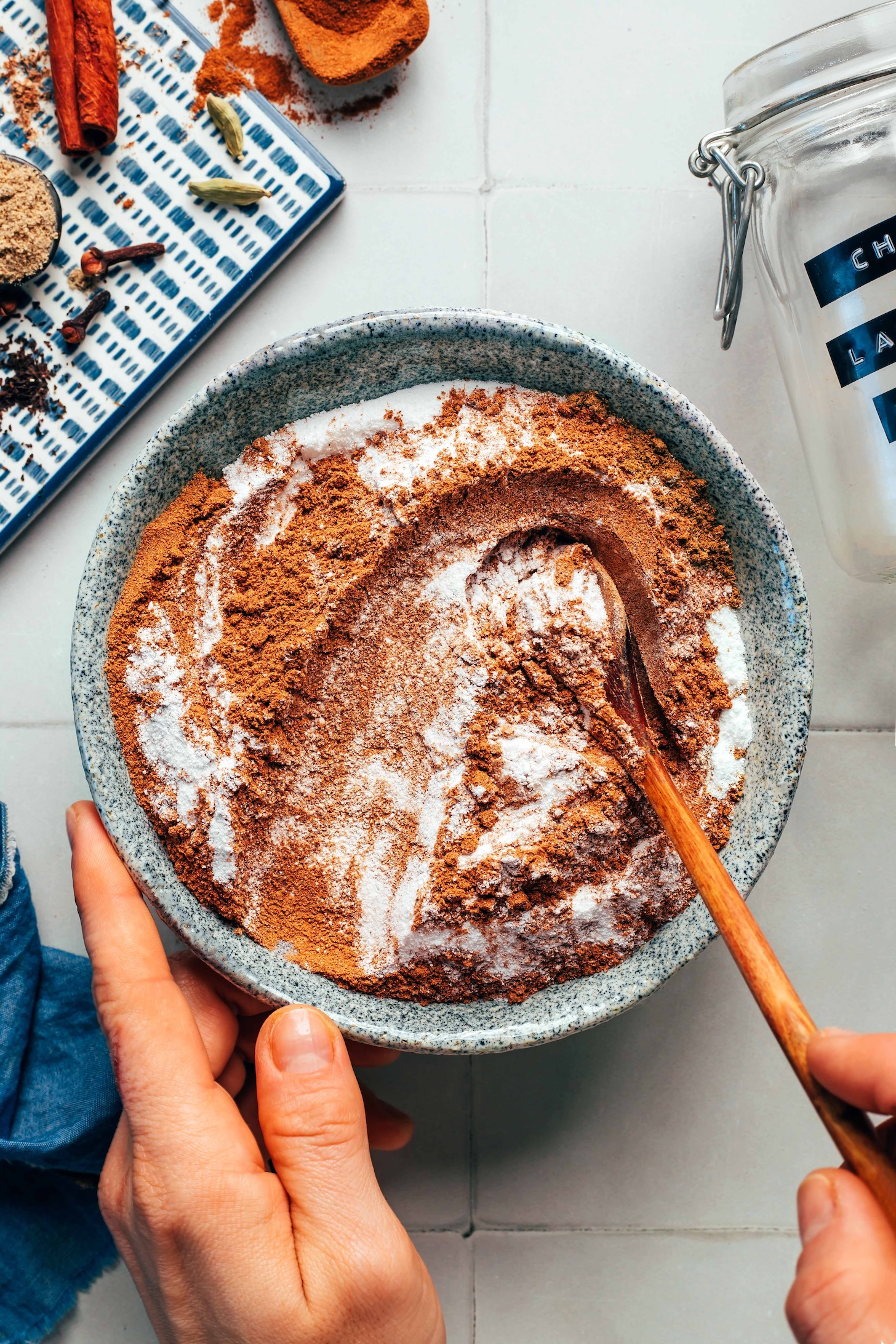 Stirring coconut milk powder into a bowl of spices