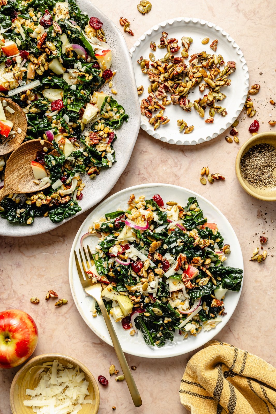 apple kale farro salad on a platter and on a side plate