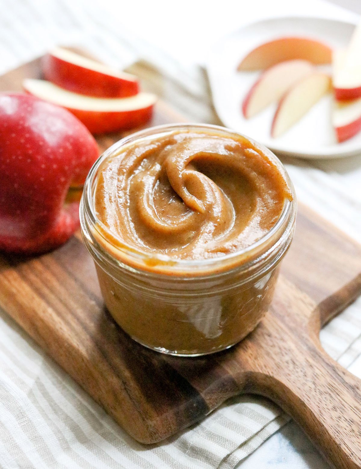 date caramel dip in a glass jar on wooden board.