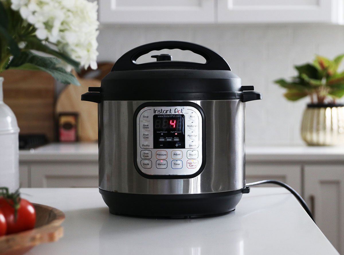 instant pot set to cook for 4 minutes on a white kitchen counter.