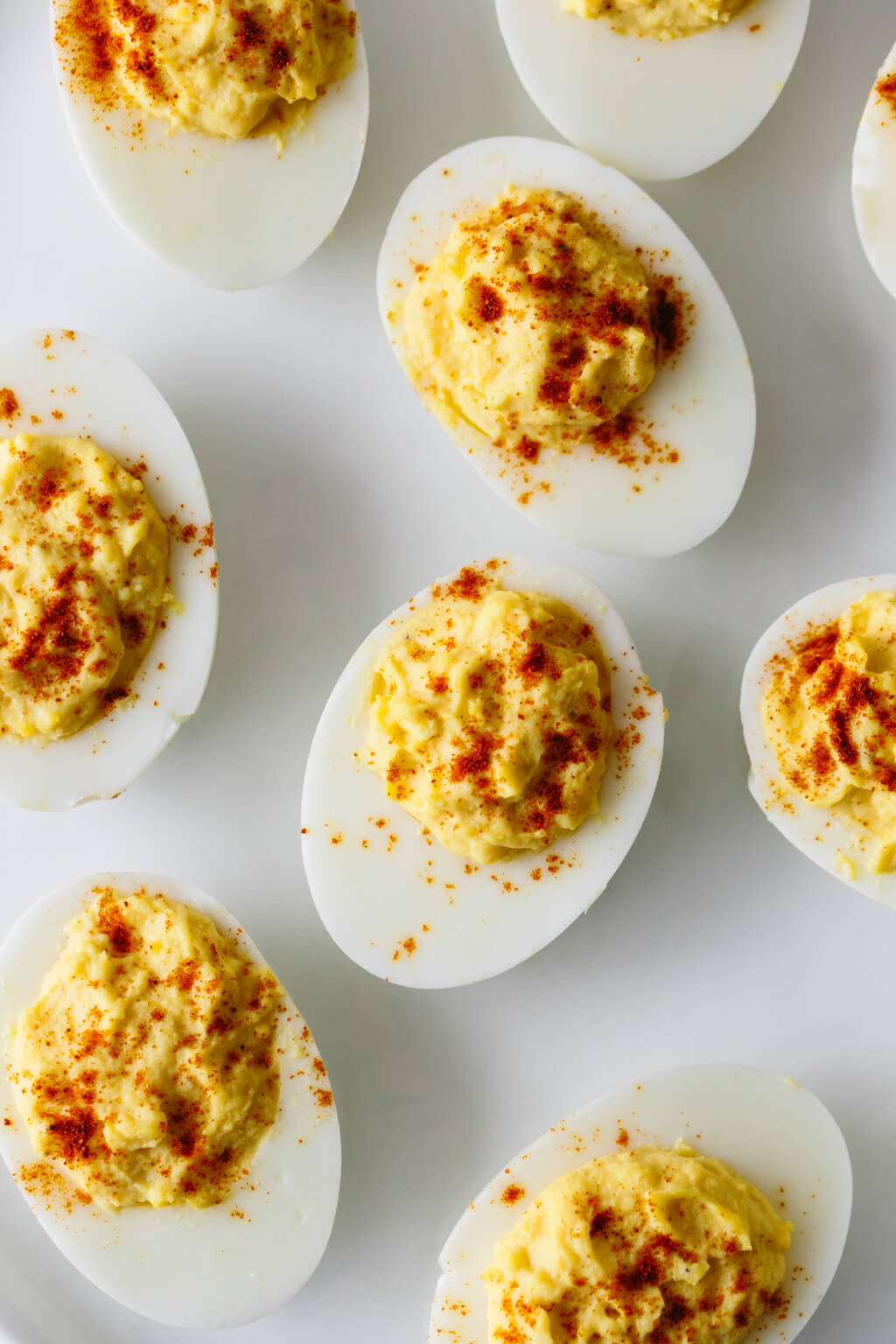 Deviled eggs are hard boiled eggs where the yolk is mixed with mayonnaise, mustard, vinegar, salt and pepper. A little sprinkle of paprika on top helps make these the best deviled eggs recipe.