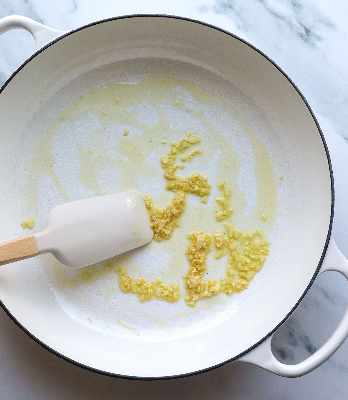 garlic sauteed briefly in olive oil in a large white skillet.