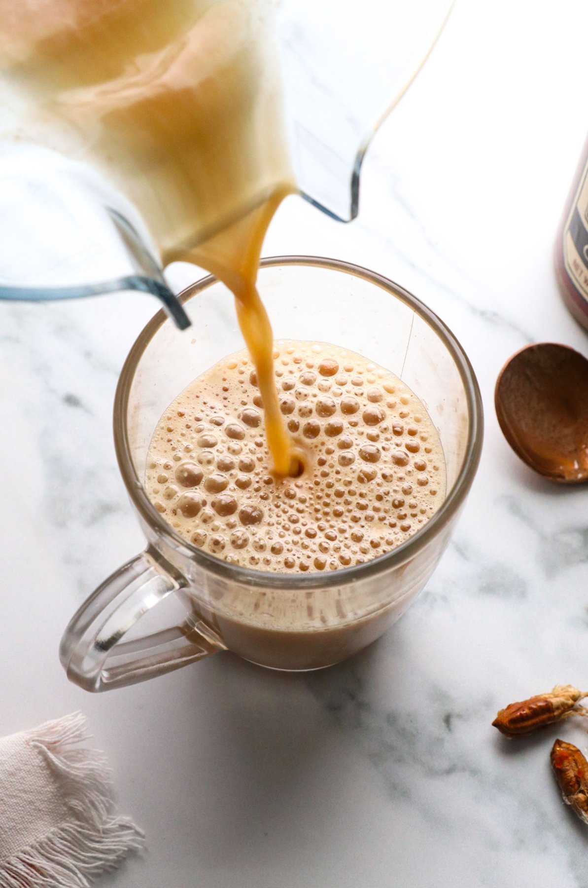 london fog poured into a glass mug from a blender.