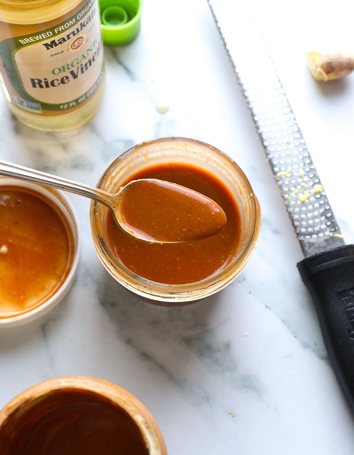 peanut dressing recipe in a jar with a spoon.