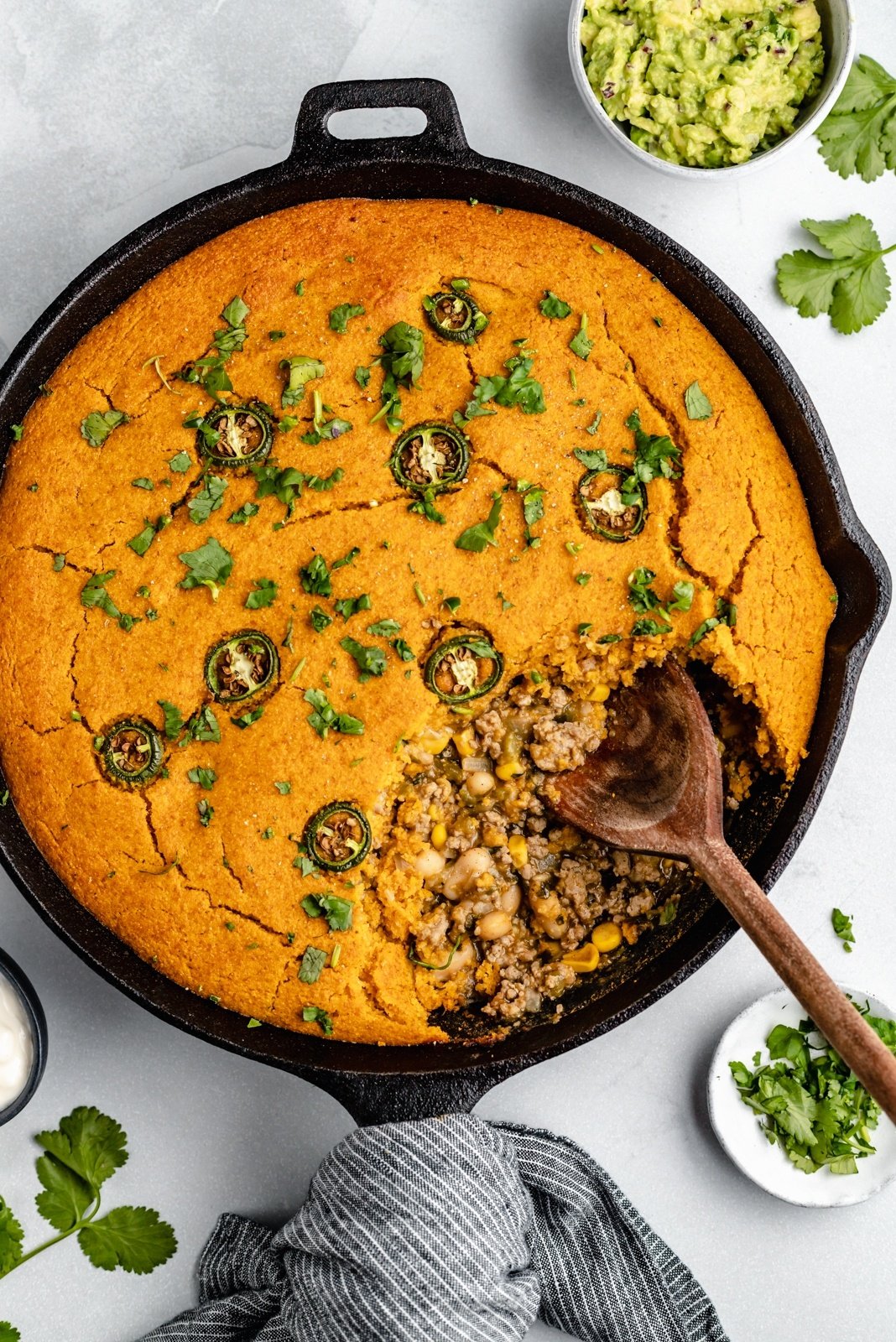 Comforting, seasonal recipes to cook in November! These healthy fall recipes are a great way to use up seasonal produce like pumpkin, winter squash, kale & sweet potatoes, and to get excited about Thanksgiving. white chicken chili pie with pumpkin cornbread crust in a skillet