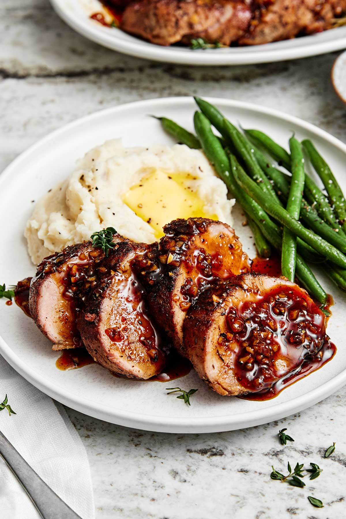 Sliced pork tenderloin with mashed potatoes.