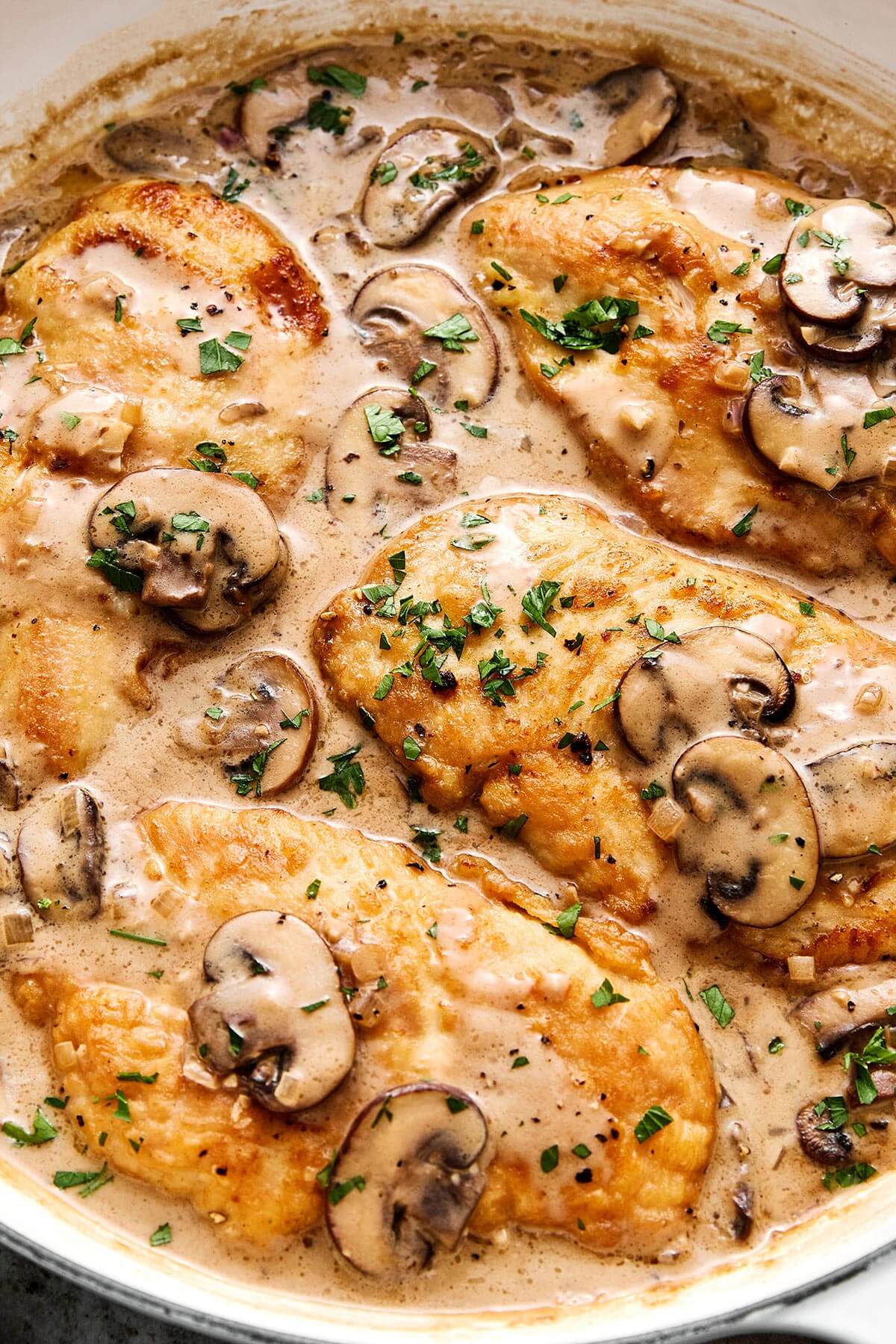 Chicken Marsala in a white pan.