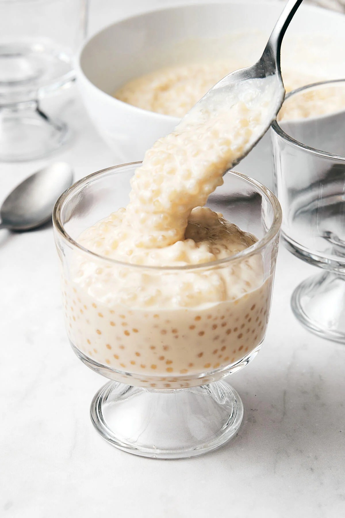 Pouring tapioca pudding into a glass.