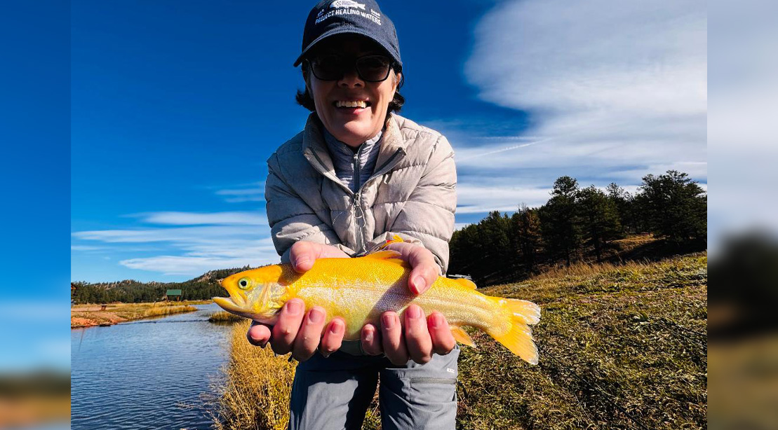 Nicole holding a golden trout